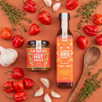 Full Feast Caribbean Hot Sauce jar and Flaming BBQ Sauce bottle with scotch bonnet chillies, garlic and thyme